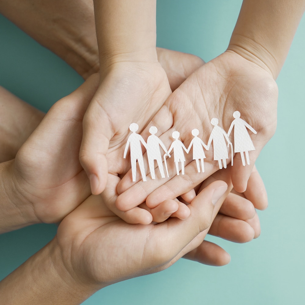Hands holding multi generation family paper, family wellness, health insurance concept