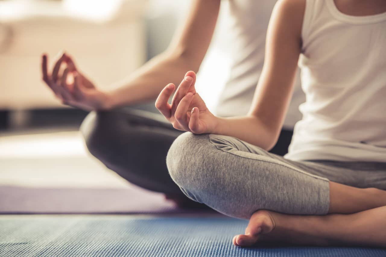 Mom and daughter doing yoga