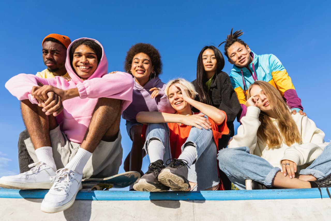 Multiracial group of young friends bonding outdoors