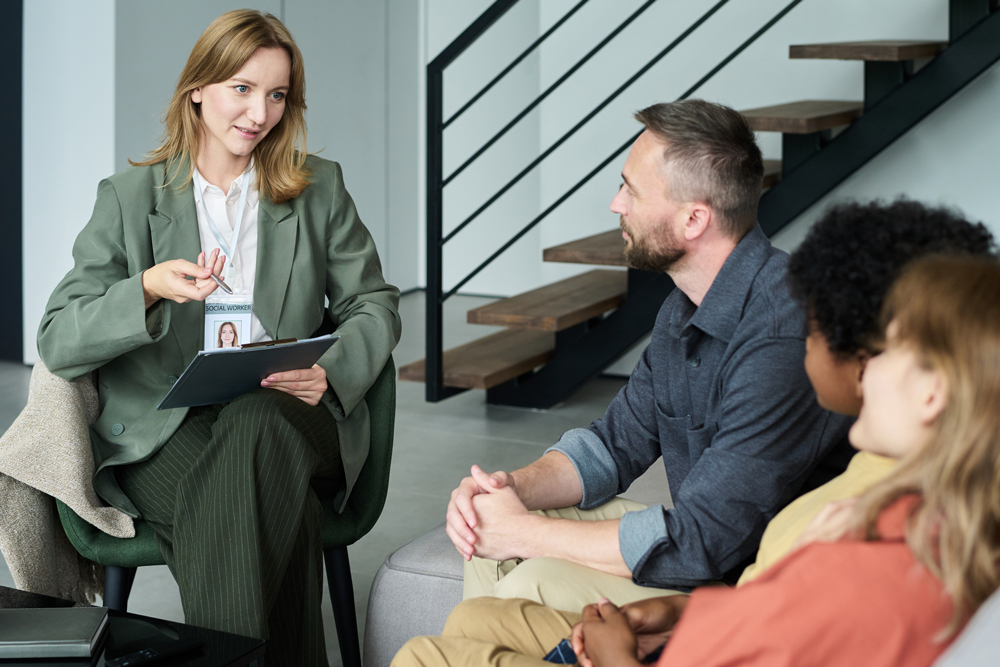 Image of a Social Worker meeting with an adoptive family.