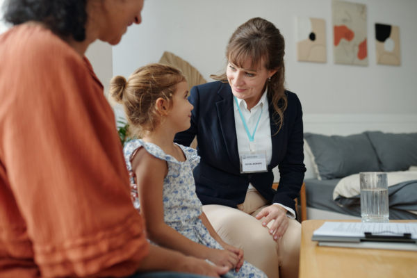 Social worker visiting a family at home and talking to them